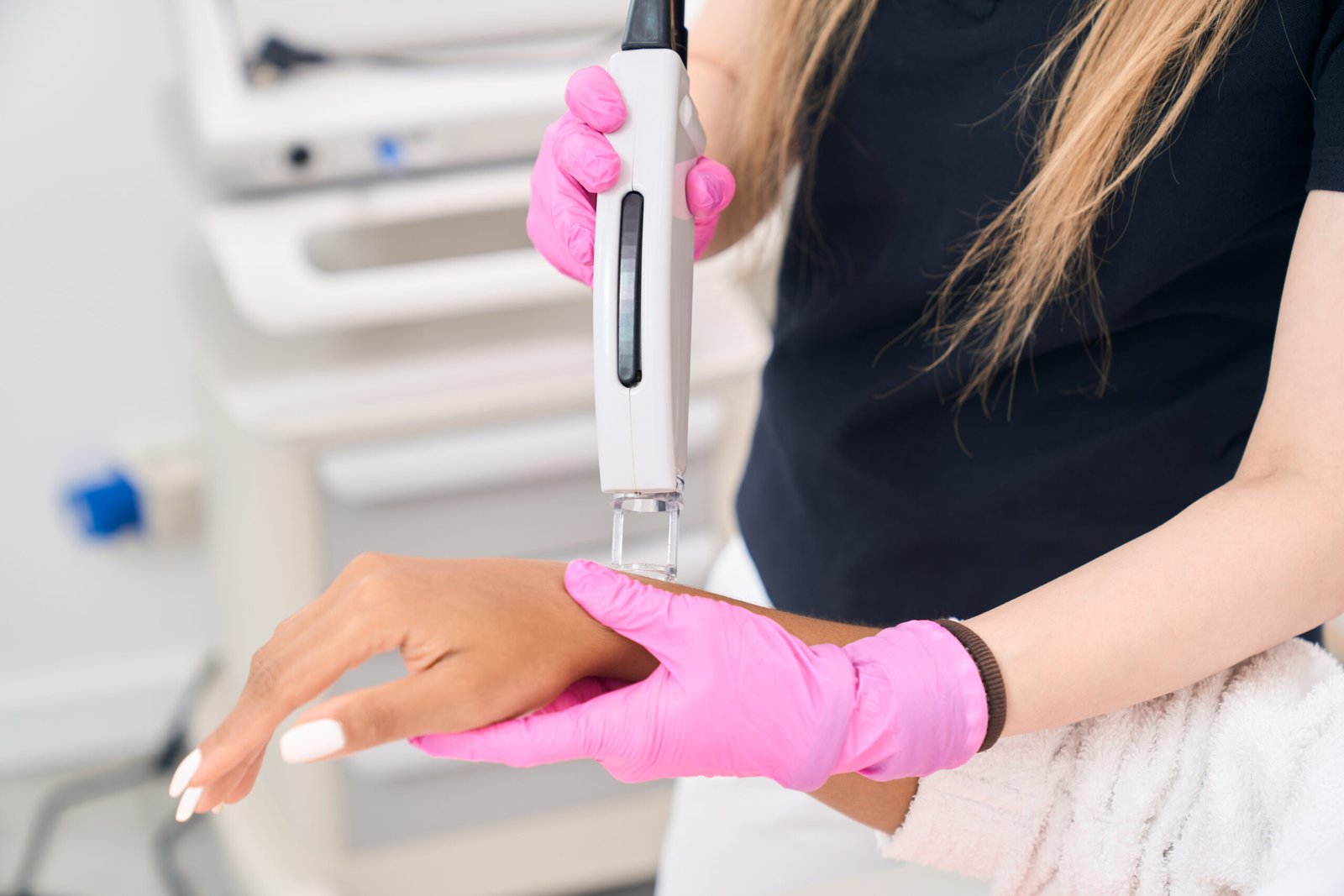 Laser treatment being performed on hands at Couture Dermatology and Laser