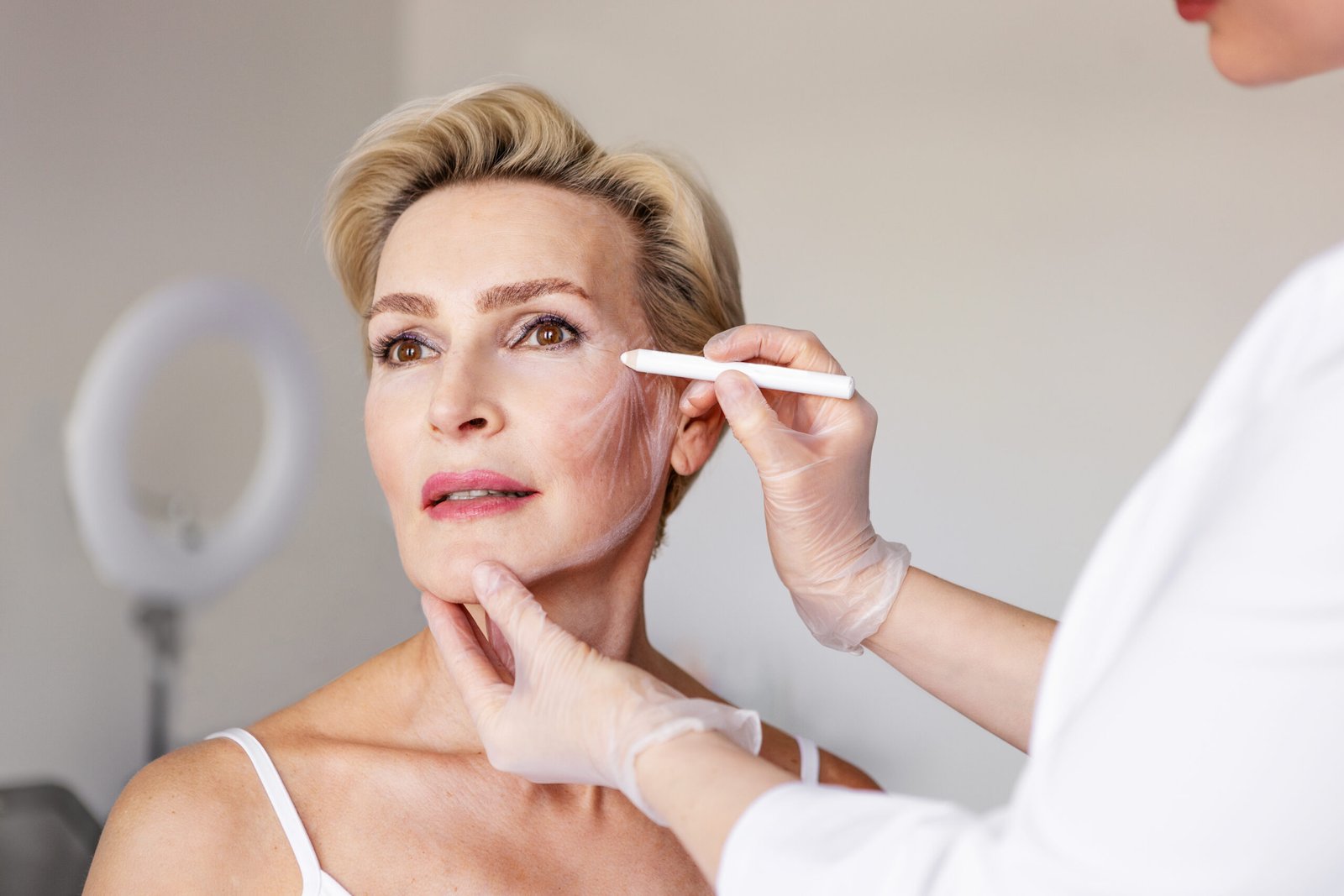 Mature woman with facial contour mapping lines for non-surgical facelift at Couture Dermatology and Laser