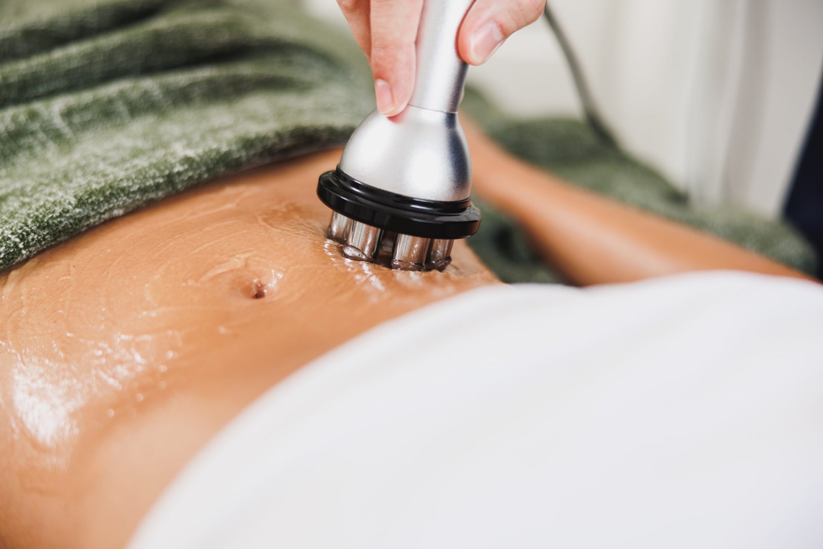 Woman enjoying radiofrequency body contouring treatment at Couture Dermatology and Laser
